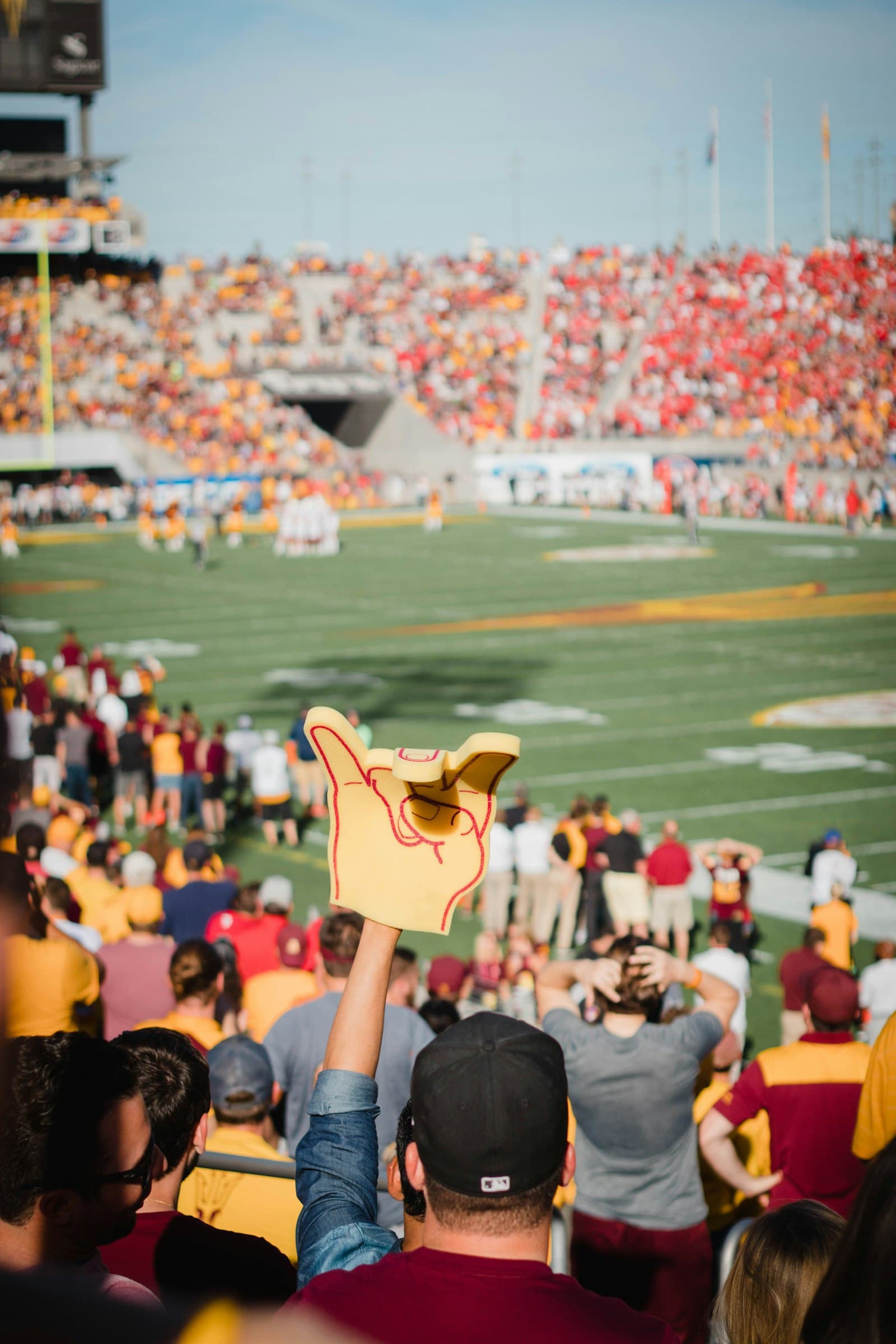 Fans cheering in the stands at a college football game