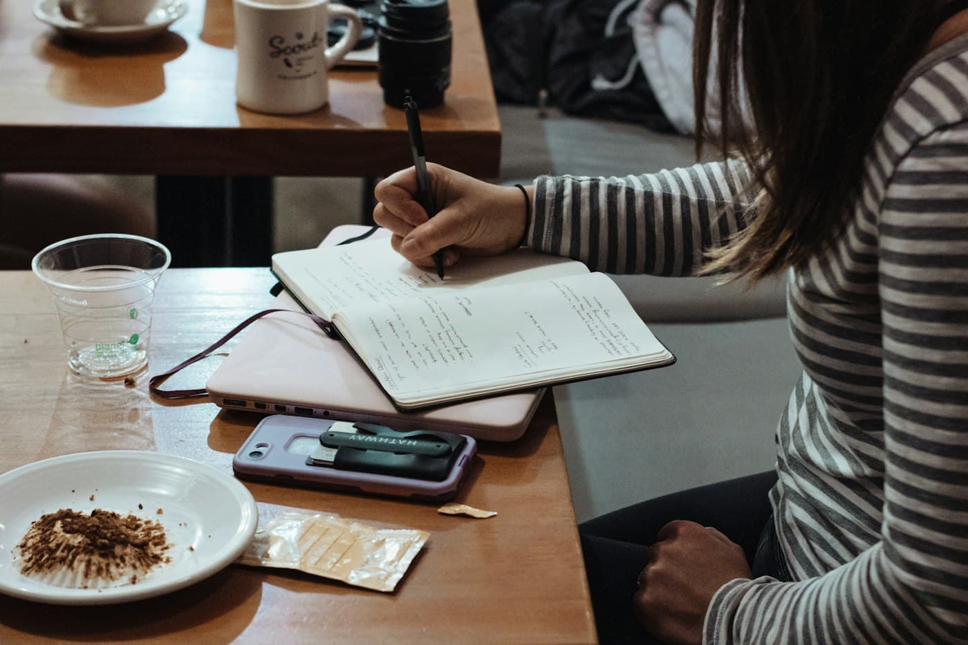 Writing notes in a notebook at a desk