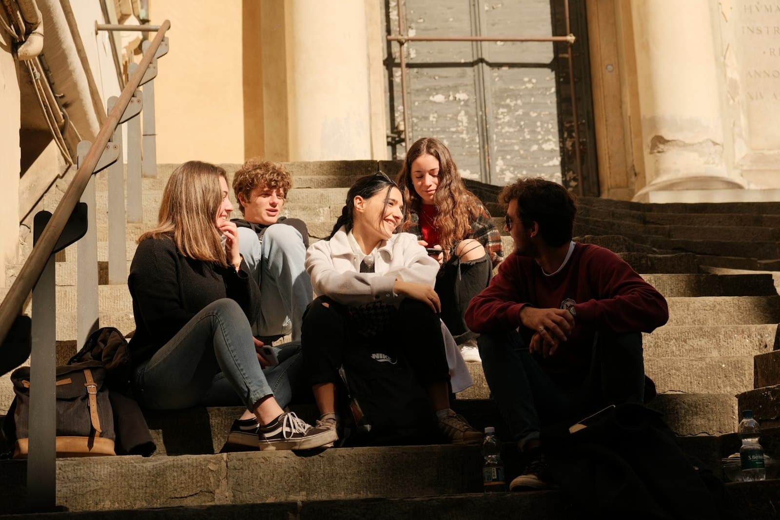 Students hanging out on the steps of a building